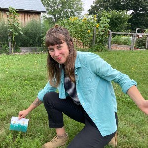 Kate Burch kneeling in grass