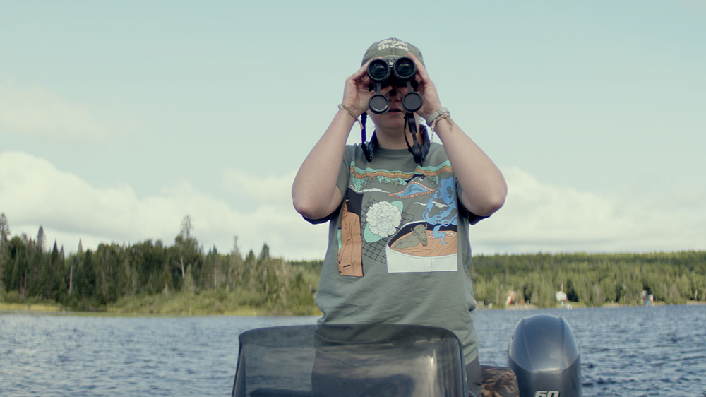 Person on a boat with binoculars