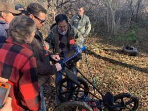 UMaine at Presque Isle Professor Chunzeng Wang discusses mapping tools with students and community volunteers