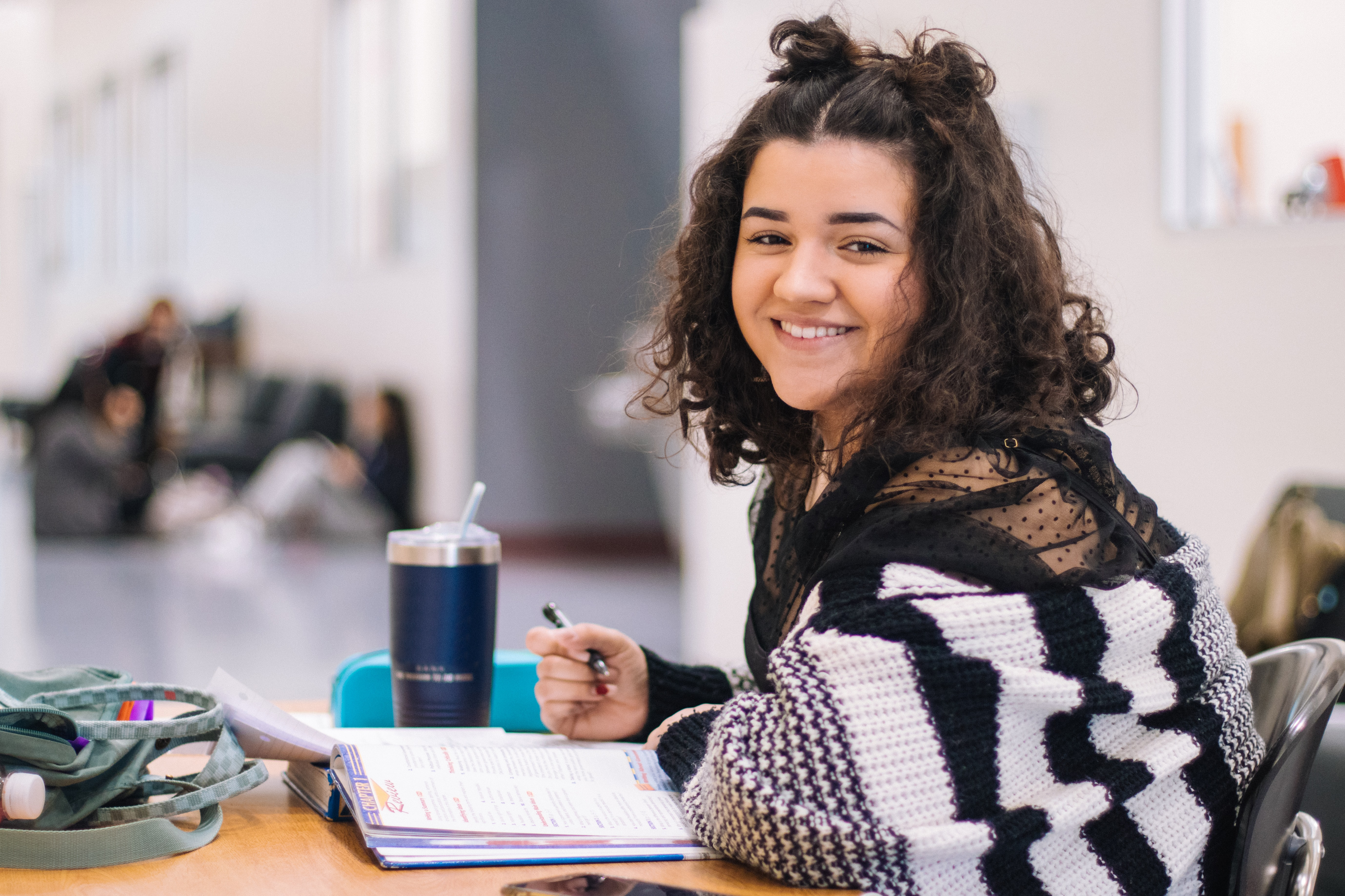 student studying at table with textbook