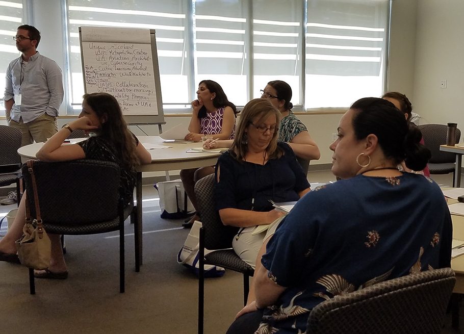 Participants listen to a presentation.