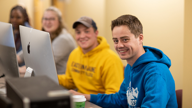 Group of people smiling for camera.
