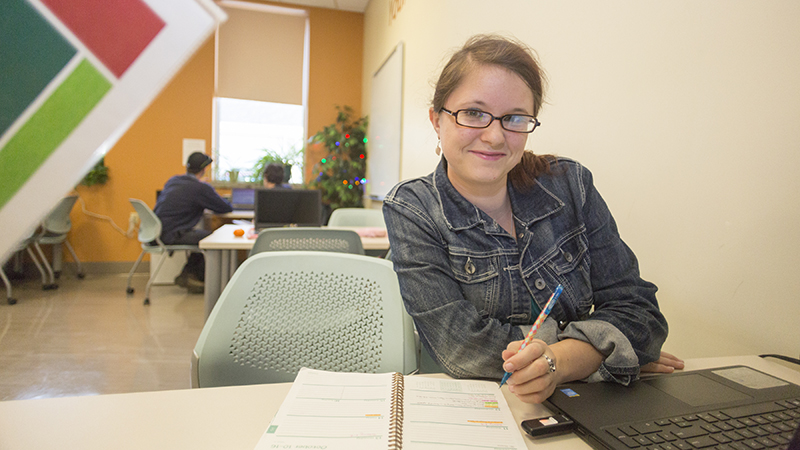 Person writing at a desk