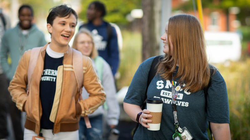 students having casual conversation while walking outside