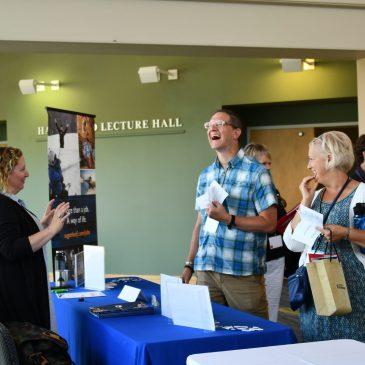 Conference exhibitor talking with conference attendees