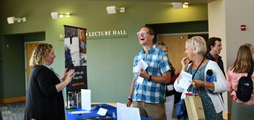 Conference exhibitor talking with conference attendees