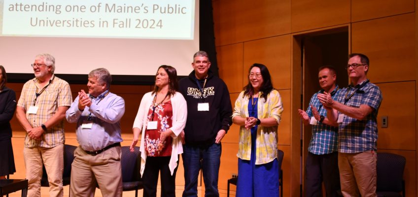 Executive committee members standing on stage