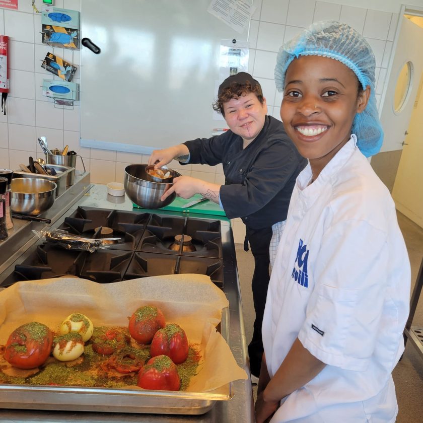 Students cooking in an industrial kitchen