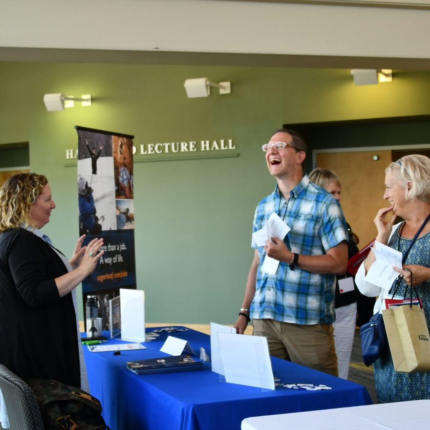 Conference exhibitor talking with conference attendees