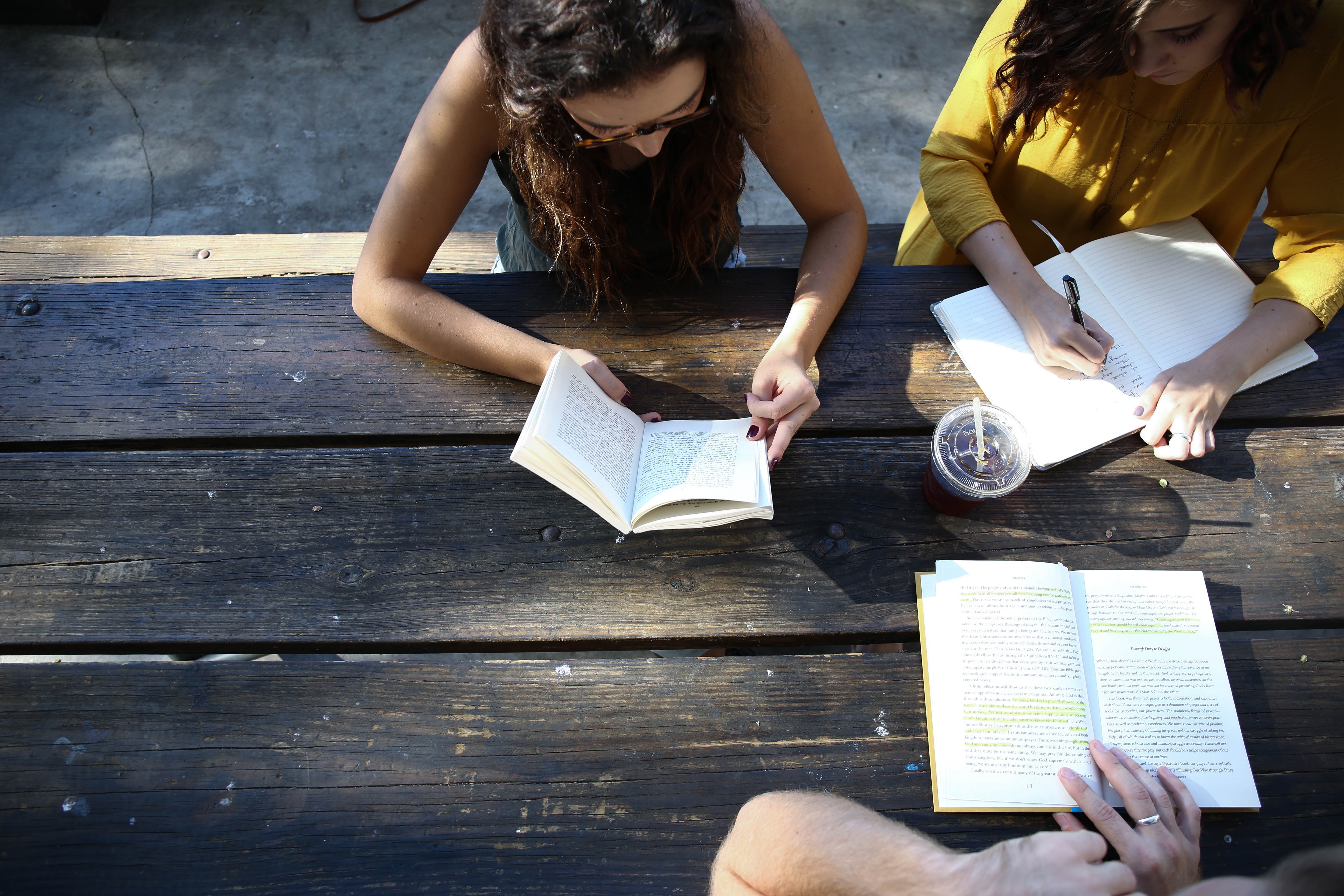 Top view of people studying at a table.