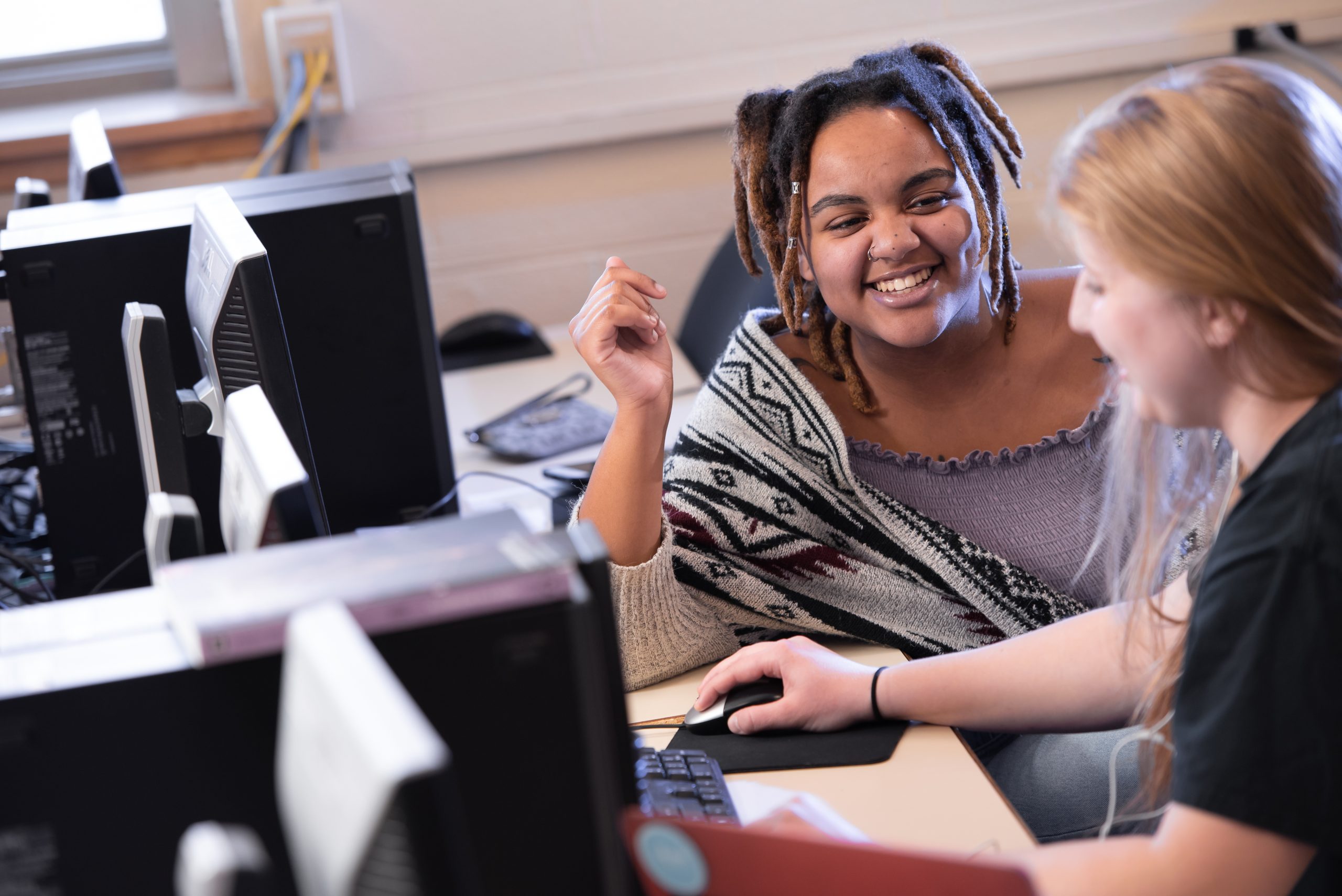 Student sitting at a table smiling