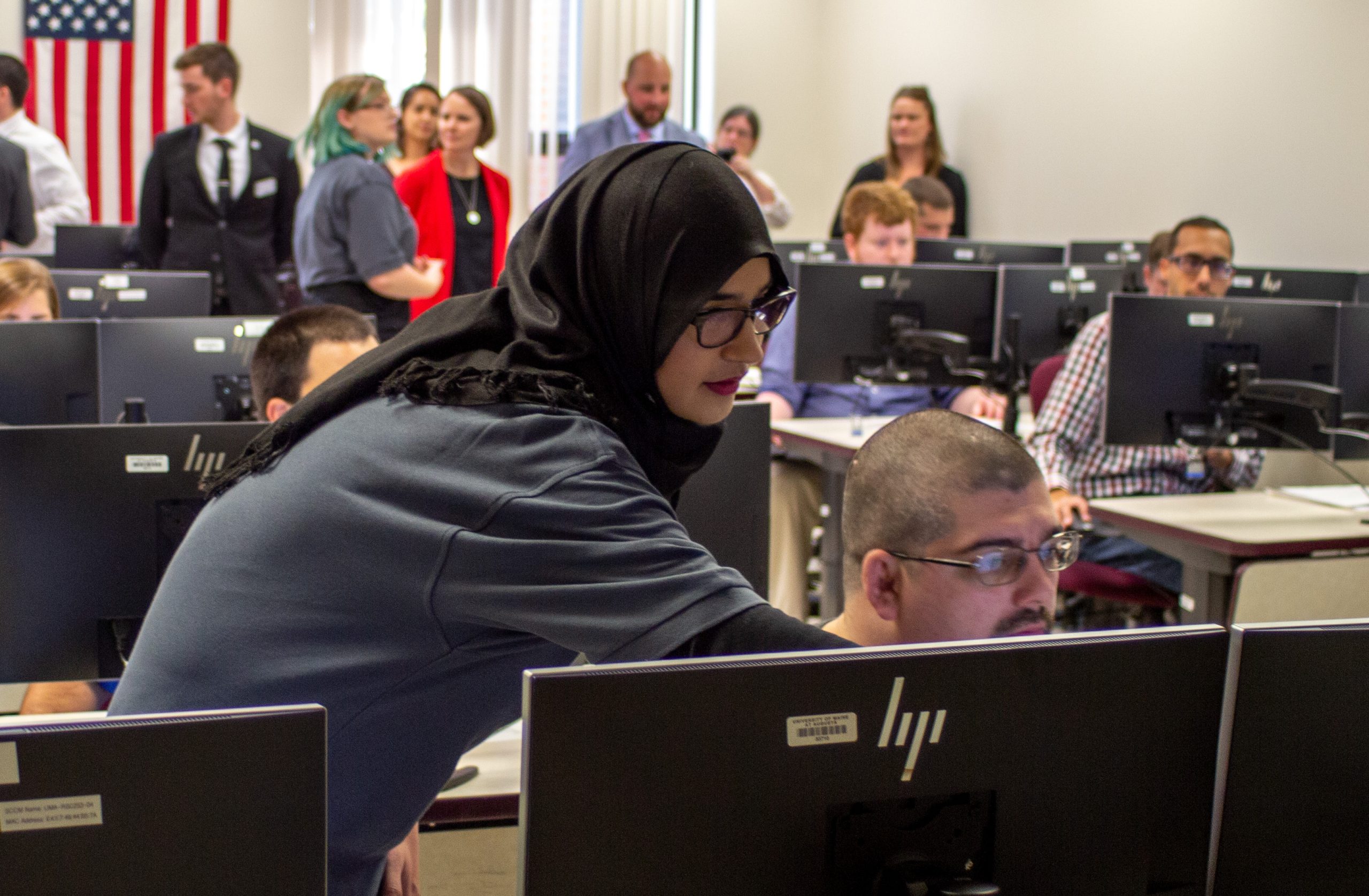 Students at the cyber range opening event; link to Frequently Asked Questions