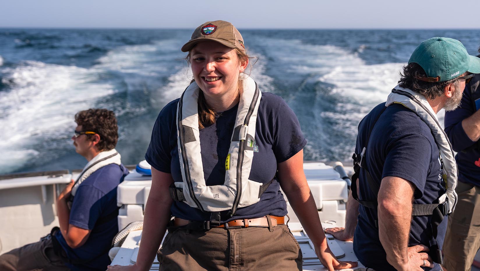 UMaine students conducting marine research on a vessel — representing workforce programs